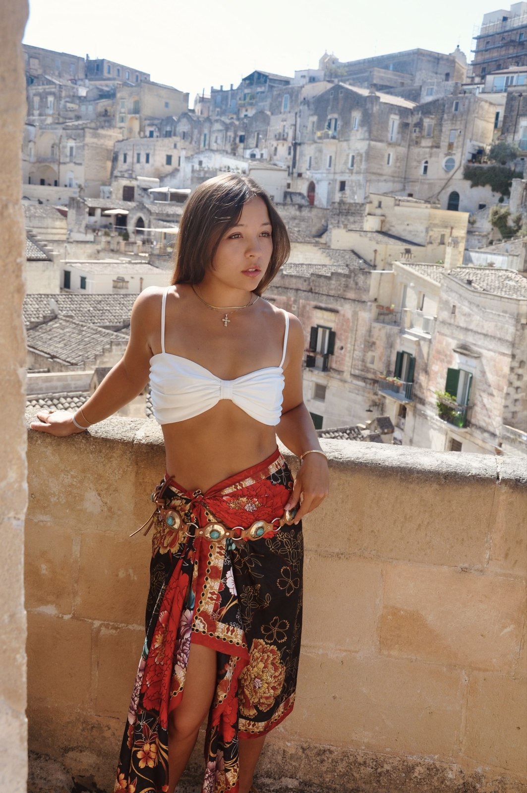 Samantha on a balcony overlooking historic architecture in Matera, Italy